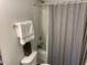 Cozy bathroom with shower featuring a shower curtain, a toilet, and basic amenities at 4910 Briarstone Ct, Raleigh, NC 27610
