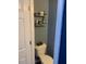 Efficient half bathroom with shelving for storage at 4910 Briarstone Ct, Raleigh, NC 27610