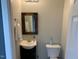 Charming bathroom featuring a rustic wood-framed mirror and a stylishly tiled backsplash at 4910 Briarstone Ct, Raleigh, NC 27610