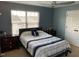 Comfortable bedroom featuring a queen-size bed, soft carpet, and a bright window view at 4910 Briarstone Ct, Raleigh, NC 27610