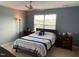 Comfortable bedroom featuring a queen-size bed, soft carpet, and a bright window view at 4910 Briarstone Ct, Raleigh, NC 27610