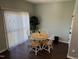 Bright dining area featuring hardwood floors, large windows, and a cozy round table at 4910 Briarstone Ct, Raleigh, NC 27610