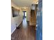 Hallway with hardwood flooring and staircase to upper level at 4910 Briarstone Ct, Raleigh, NC 27610