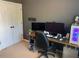 Home office with multiple monitors, a comfortable chair, and ample desk space at 4910 Briarstone Ct, Raleigh, NC 27610