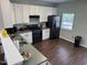 Kitchen featuring stainless steel appliances, modern lighting, and an airy atmosphere at 4910 Briarstone Ct, Raleigh, NC 27610
