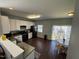Eat in Kitchen with hardwood floors, stainless appliances, and light colored walls at 4910 Briarstone Ct, Raleigh, NC 27610