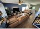 Comfortable living room featuring a large sectional sofa, television, and hardwood floors at 4910 Briarstone Ct, Raleigh, NC 27610