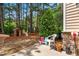 Lush backyard with mature trees, playhouse, and patio featuring outdoor seating at 513 Commons Dr, Holly Springs, NC 27540