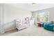 Bright bedroom with ample natural light, colorful decor, and cozy carpet at 513 Commons Dr, Holly Springs, NC 27540