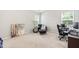 Cozy bedroom/office space with a comfortable chair, desk, and window for natural light and productivity at 513 Commons Dr, Holly Springs, NC 27540