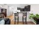Open kitchen features stainless steel appliances, granite countertops, and a breakfast bar with seating at 513 Commons Dr, Holly Springs, NC 27540