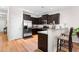 This spacious kitchen offers dark wood cabinets, stainless steel appliances, and a breakfast bar at 513 Commons Dr, Holly Springs, NC 27540