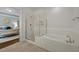 Well-appointed bathroom features a walk-in shower, soaking tub, and modern fixtures at 5217 Beckom St, Raleigh, NC 27616