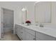 Bathroom vanity with dual sinks, a white countertop, and framed mirrors at 5217 Beckom St, Raleigh, NC 27616