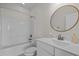 Bright bathroom featuring a tub with shower and white vanity at 5217 Beckom St, Raleigh, NC 27616