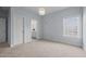 Bright bedroom featuring light blue walls, carpet, and a view to a bathroom at 5217 Beckom St, Raleigh, NC 27616