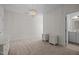 Bright bedroom featuring white walls, carpet, chandelier and a view to a bathroom at 5217 Beckom St, Raleigh, NC 27616