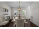 Bright dining room boasts natural light, a stylish chandelier, and seating for six at 5217 Beckom St, Raleigh, NC 27616