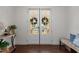 Elegant entryway with glass-paneled double doors, hardwood floors, and stylish decor that creates a warm welcome at 5217 Beckom St, Raleigh, NC 27616
