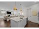 Open-concept kitchen with a large island, seamlessly connected to the cozy living area at 5217 Beckom St, Raleigh, NC 27616