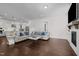 Spacious living room with hardwood flooring and a fireplace, open to the kitchen and dining areas at 5217 Beckom St, Raleigh, NC 27616