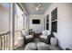 Stylish screened porch with comfortable seating, rug, ceiling fan, and outdoor views at 5217 Beckom St, Raleigh, NC 27616