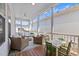Inviting screened porch with outdoor furniture, ceiling fans, and scenic views at 5217 Beckom St, Raleigh, NC 27616