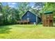 Spacious backyard featuring a deck, playset, and lush green lawn, perfect for Gathering gatherings at 5346 Deep River Rd, Sanford, NC 27330