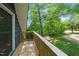Wooden balcony with an overview of the lush greenery in the backyard at 5346 Deep River Rd, Sanford, NC 27330