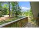 Wooden balcony offering views of the yard and surrounding greenery at 5346 Deep River Rd, Sanford, NC 27330