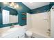 Contemporary bathroom featuring a white vanity, stylish mirror, and a shower-tub combination at 5346 Deep River Rd, Sanford, NC 27330
