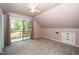Cozy bedroom featuring a ceiling fan, access to a private balcony, and neutral carpet at 5346 Deep River Rd, Sanford, NC 27330