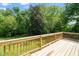 Exterior view of a wooden deck overlooking the serene wooded yard at 5346 Deep River Rd, Sanford, NC 27330