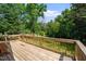 Exterior view of a wooden deck overlooking the spacious backyard at 5346 Deep River Rd, Sanford, NC 27330