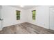 Well-lit dining area with light gray floors and views of the outdoors through two large windows at 5346 Deep River Rd, Sanford, NC 27330
