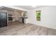 Bright dining area with light gray floors, offering an open view of the kitchen and backyard at 5346 Deep River Rd, Sanford, NC 27330