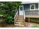 Exterior home entry with wooden steps and mature tree at 5346 Deep River Rd, Sanford, NC 27330