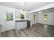 Bright kitchen featuring stainless steel appliances, gray cabinets, and granite countertops with an adjacent eating area at 5346 Deep River Rd, Sanford, NC 27330