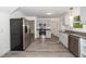 Spacious kitchen featuring stainless steel appliances, gray cabinets, and durable wood-look flooring at 5346 Deep River Rd, Sanford, NC 27330