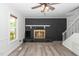Inviting living room with a black brick fireplace and light gray floors, bathed in natural light at 5346 Deep River Rd, Sanford, NC 27330