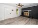 Cozy living room with a black brick fireplace, light gray floors, and a ceiling fan at 5346 Deep River Rd, Sanford, NC 27330