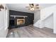 Comfortable living room featuring a fireplace, light gray floors, and access to the staircase at 5346 Deep River Rd, Sanford, NC 27330