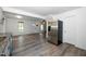 Open-concept living space featuring stainless appliances, neutral wall paint, and durable wood-look flooring at 5346 Deep River Rd, Sanford, NC 27330