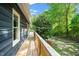 Exterior view of a wooden porch overlooking the wooded yard at 5346 Deep River Rd, Sanford, NC 27330