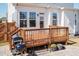 An expansive wooden back deck featuring a grill, patio, potted plants, and stone patio at 536 Adkins Ridge Rd, Rolesville, NC 27571
