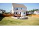 Landscaped backyard with a stone firepit, patio, wooden deck, and fenced in yard at 536 Adkins Ridge Rd, Rolesville, NC 27571