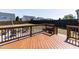 A spacious wooden deck with a grill, firepit and chairs, and a beautiful backyard view at 536 Adkins Ridge Rd, Rolesville, NC 27571