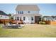 Lush backyard featuring a stone fire pit, wooden deck with seating, and well-maintained lawn for outdoor enjoyment at 536 Adkins Ridge Rd, Rolesville, NC 27571