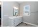 Bright bathroom with ample counter space, white cabinetry, and large mirror for a functional design at 536 Adkins Ridge Rd, Rolesville, NC 27571