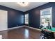 Bedroom bathed in natural light with hardwood floors and fresh blue walls, creating a relaxing and modern space at 536 Adkins Ridge Rd, Rolesville, NC 27571